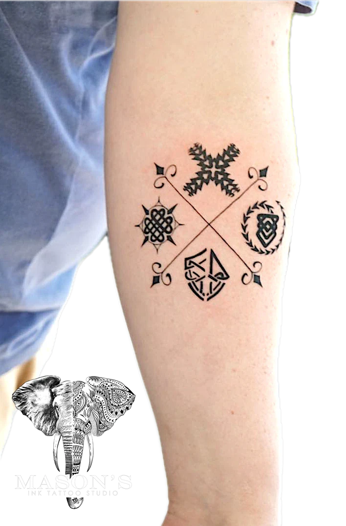 Tribal symbolic motifs arranged in a cross pattern tattoo by Mason's Ink Tattoo Studio, Bali