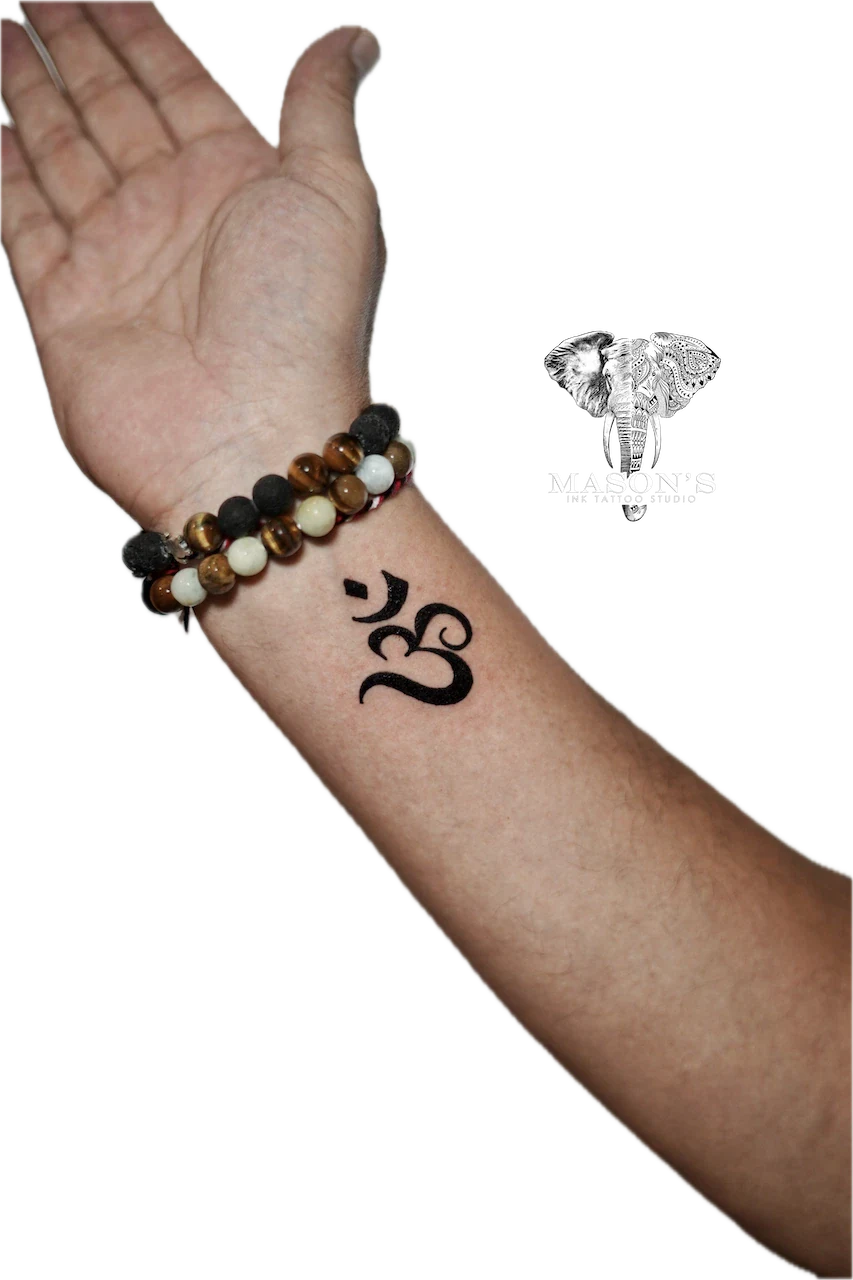 Blackwork Om script tattoo by Mason's Ink Tattoo Studio, Bali