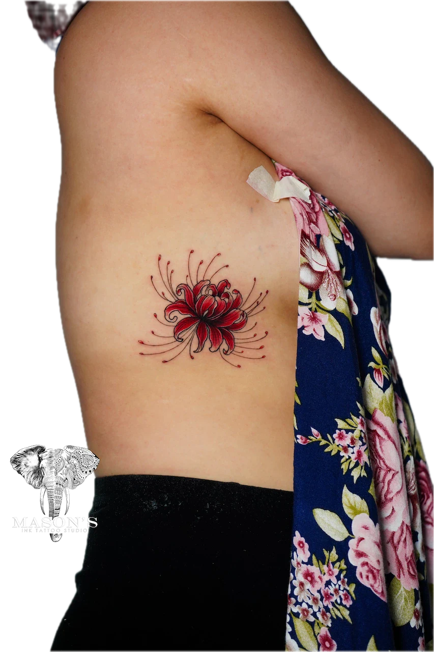 Color Floral Tattoo Design: a vibrant red flower with detailed petals on the hip