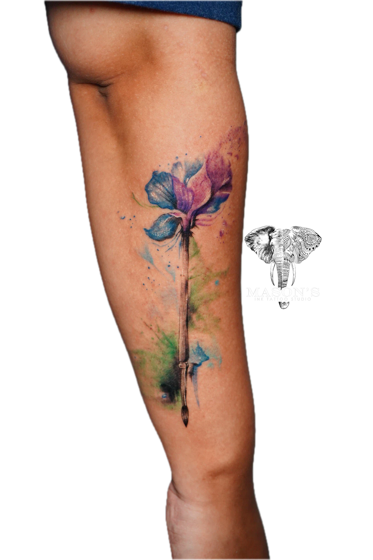 Colored Floral Tattoo Style Design: a watercolor flower with a brush and blade on a calf
