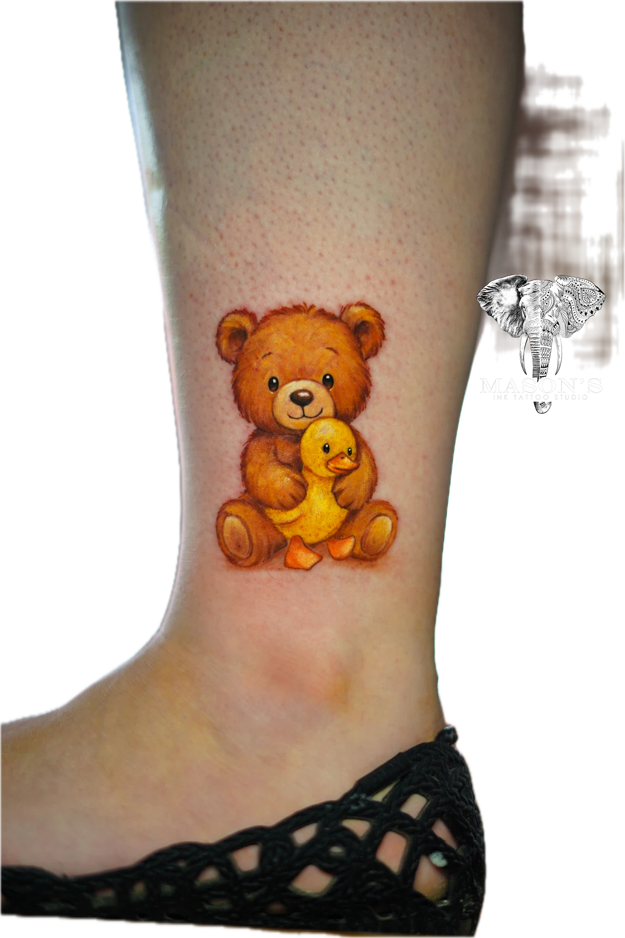 Color Tattoo Style Bear Design: a small bear holding a duck toy on the calf