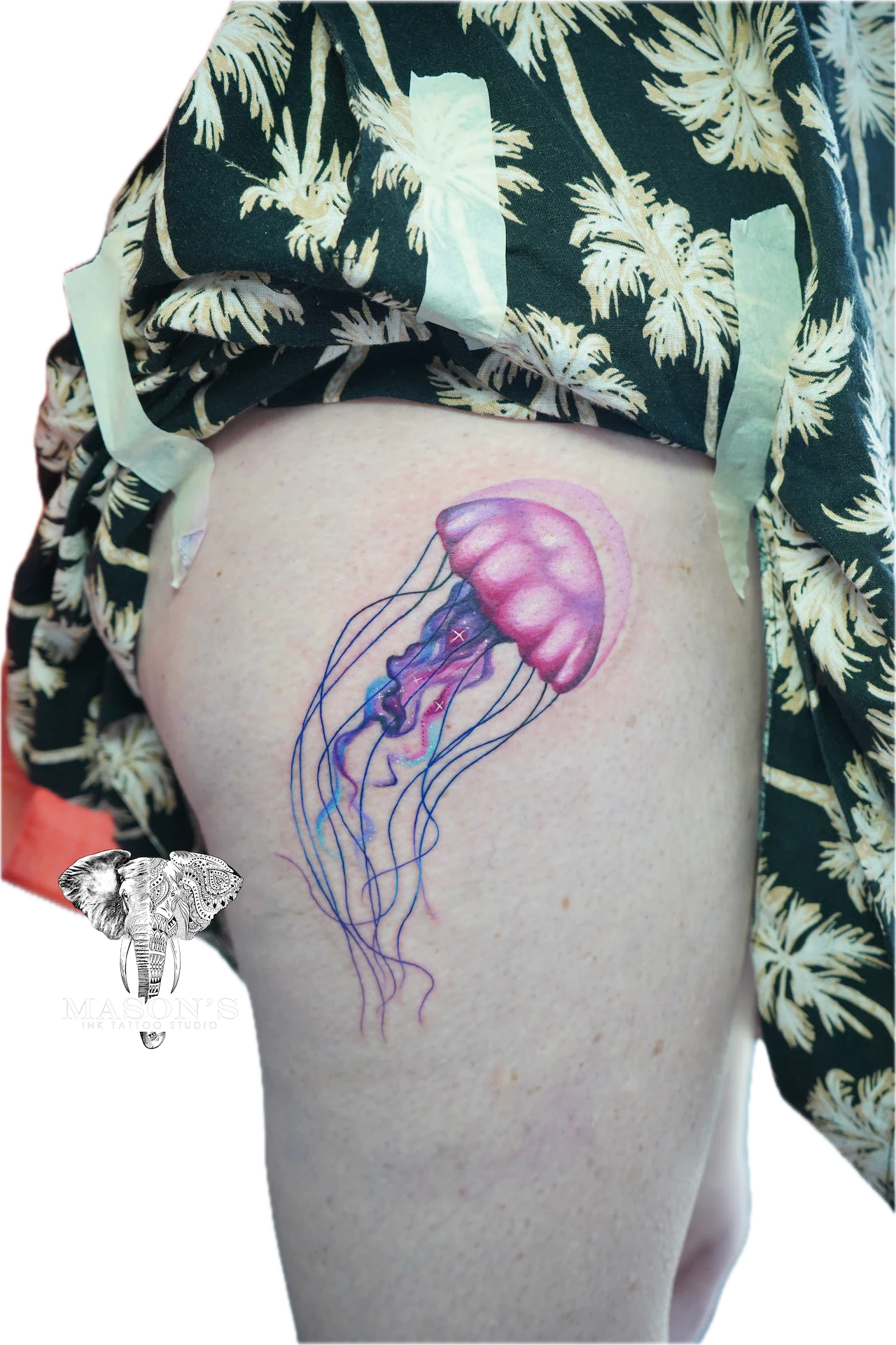 Color Jellyfish Tattoo Design: a colorful jellyfish with flowing tentacles on the thigh