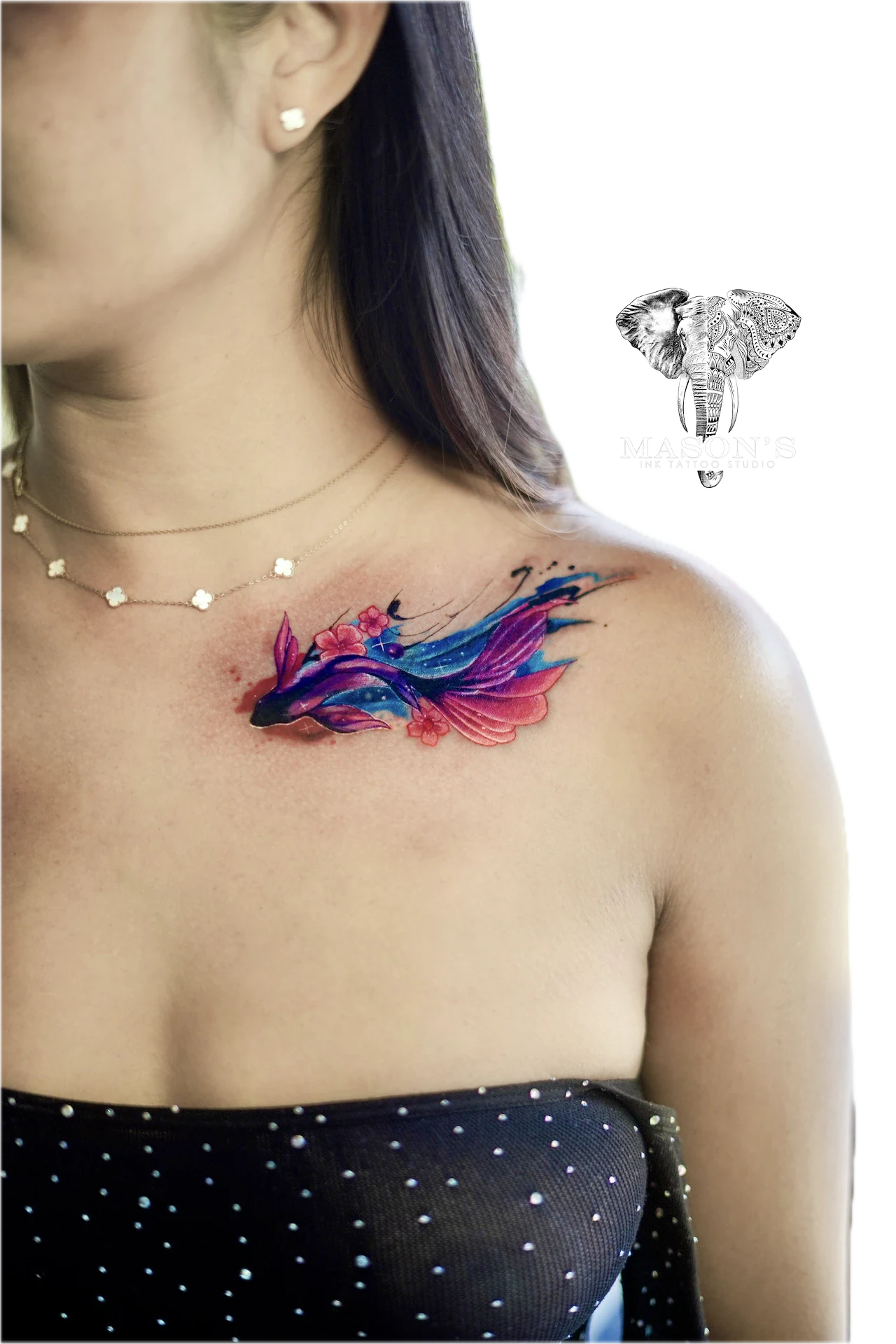 Color Fish Tattoo Design: a colorful fish with feathers and flowers on the shoulder