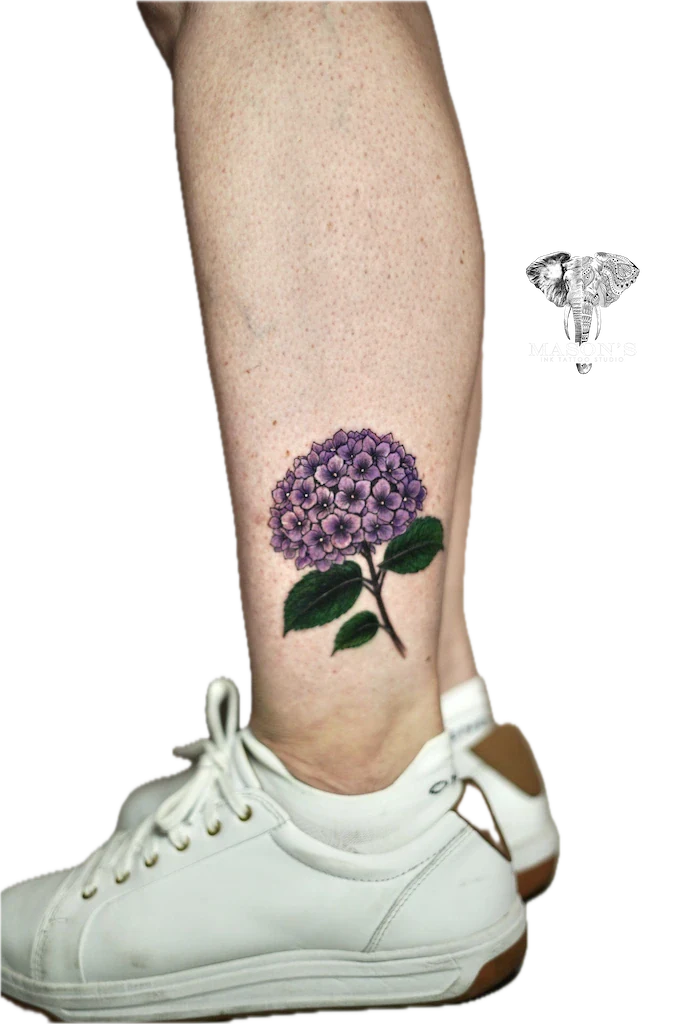 Color Floral Tattoo Design: a small purple flower tattoo on the calf