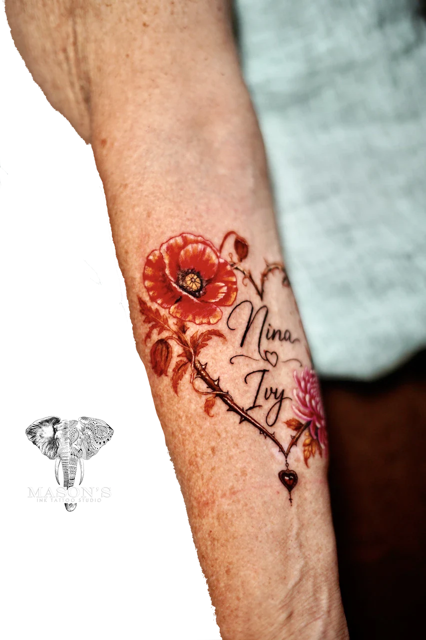 Custom Floral and Script Color Tattoo Design: a colorful floral tattoo with lettering on a forearm