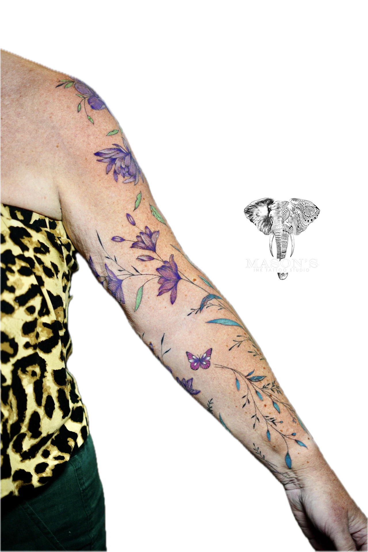 Colored Floral Tattoo Style Design: a colorful floral design with butterflies on the upper arm