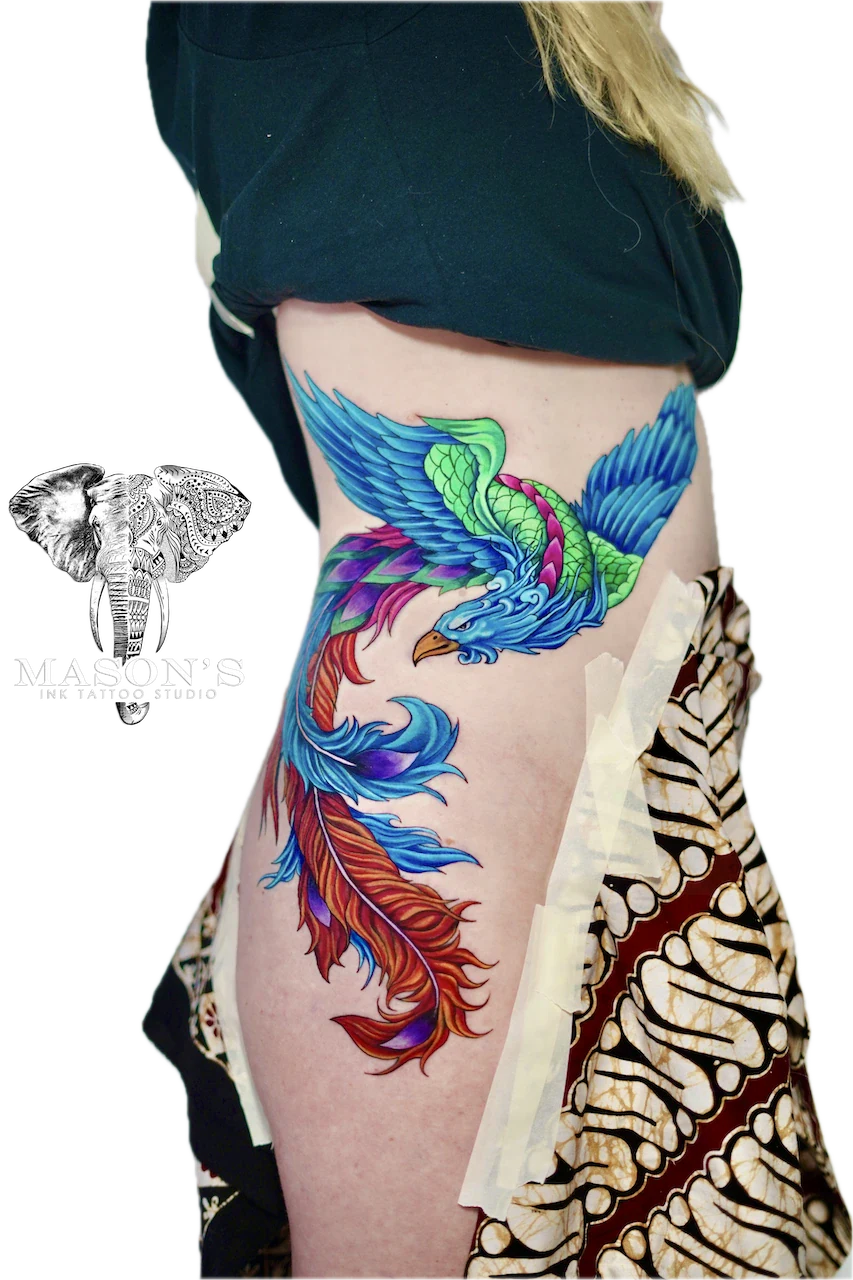 Vibrant Custom Phoenix Color Tattoo Design: a vibrant phoenix with colorful feathers on the hip