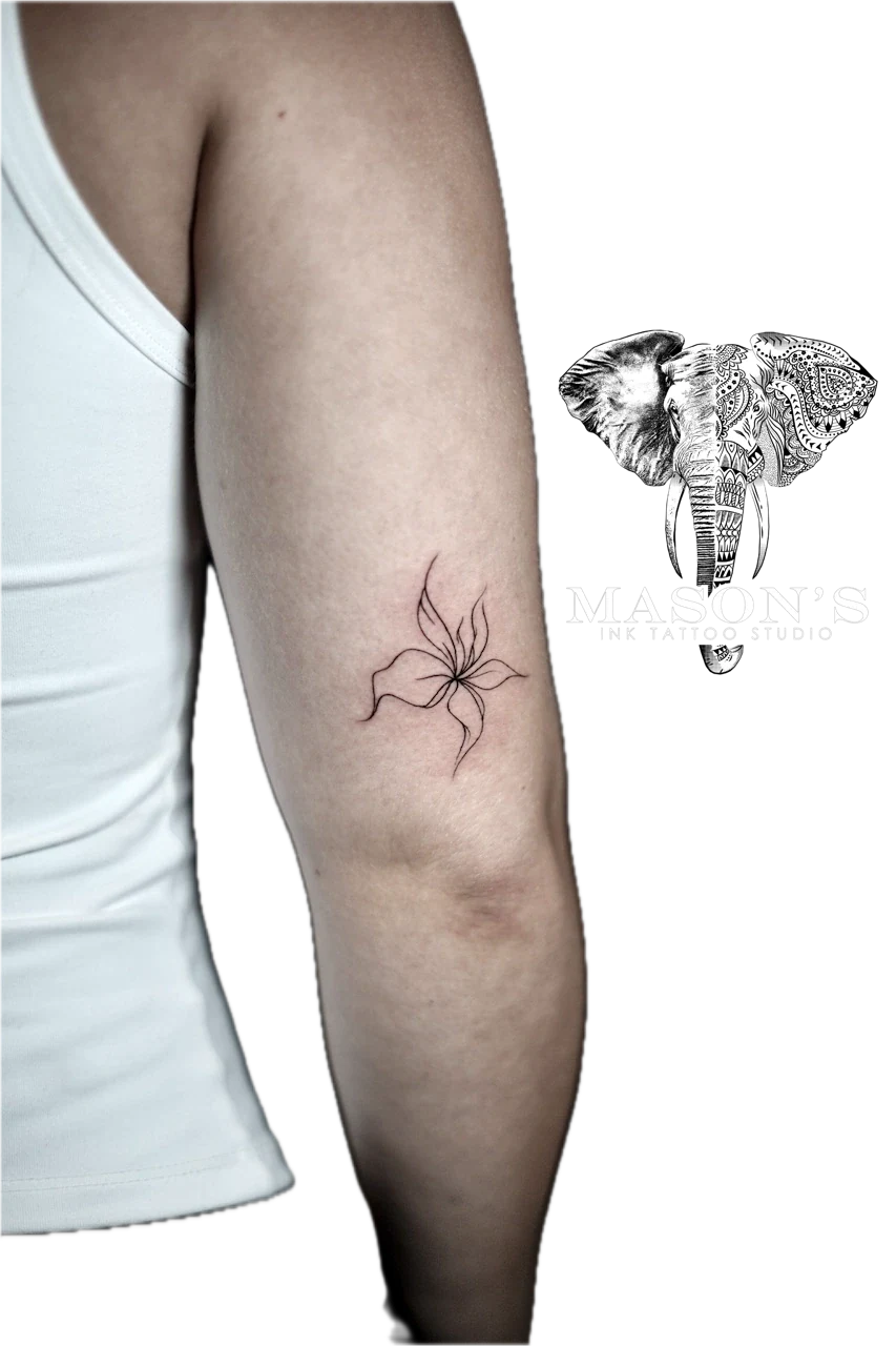 Fine Line Floral Tattoo Design: a minimal black and grey flower tattoo on the forearm