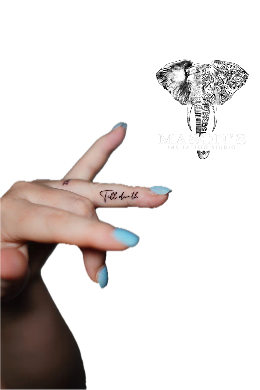 Fine Line Script Tattoo Design: Minimal black and grey lettering on a finger