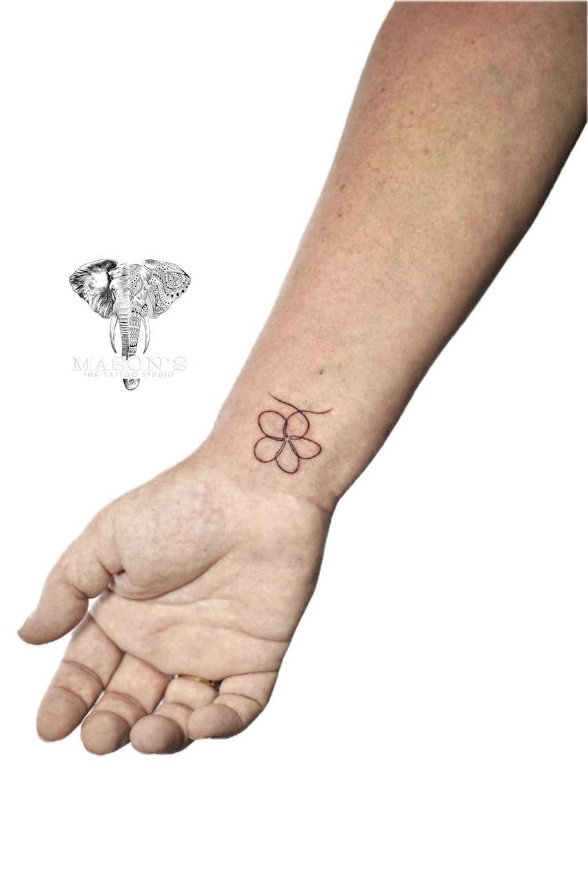 Fine Line Floral Tattoo Design: a small geometric flower tattoo on the wrist
