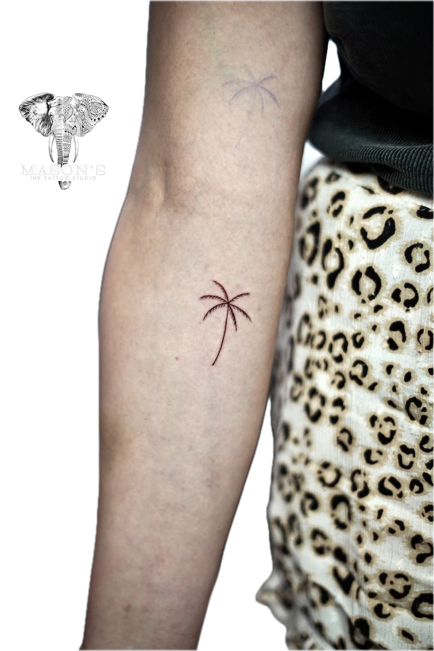 Fine Line Palm Tree Tattoo Design: Two small palm tree tattoos on the forearm
