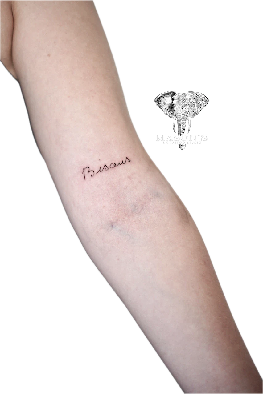 Fine Line Script Tattoo Design: Small cursive lettering on the forearm