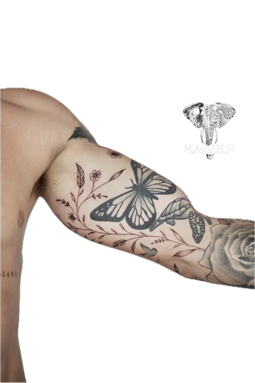 Fine Line Floral Tattoo Design: a butterfly and flowers on a forearm with minimalist design