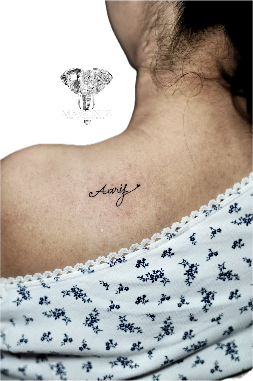 Fine Line Script Tattoo Design: a small script lettering tattoo on the shoulder