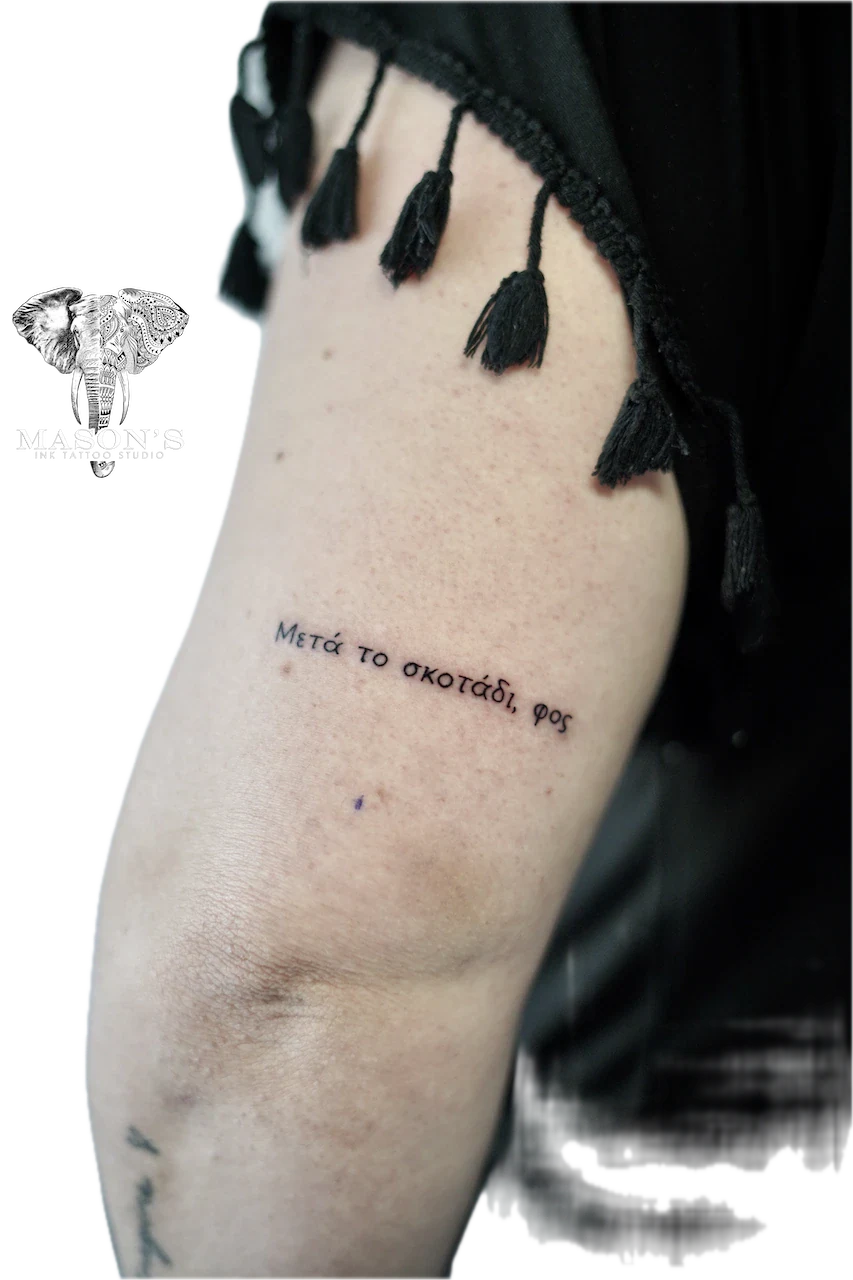 Fine Line Script Tattoo Design: Greek lettering on thigh with tassels and rope design
