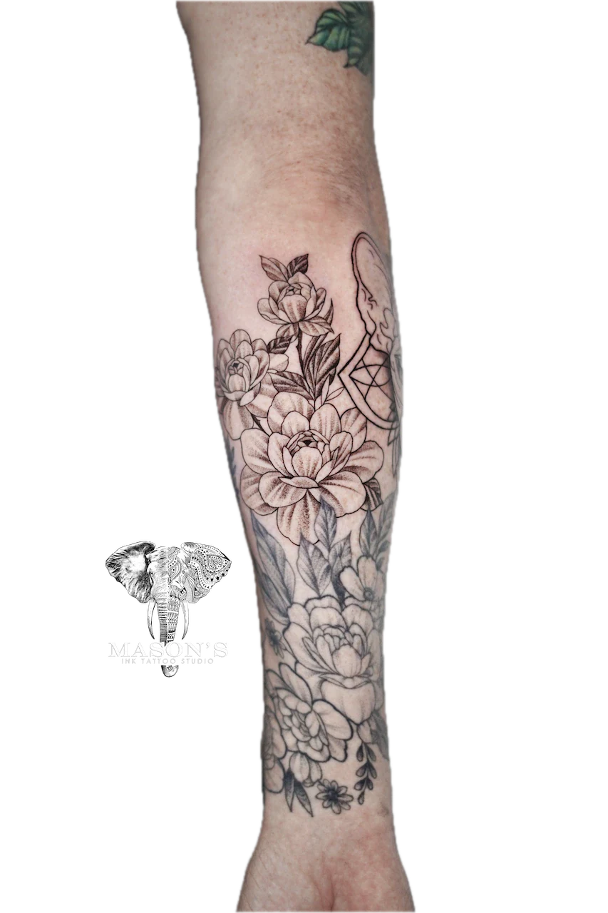 Fine Line Floral Flower Tattoo Design: a large floral tattoo with detailed leaves and vines on the forearm