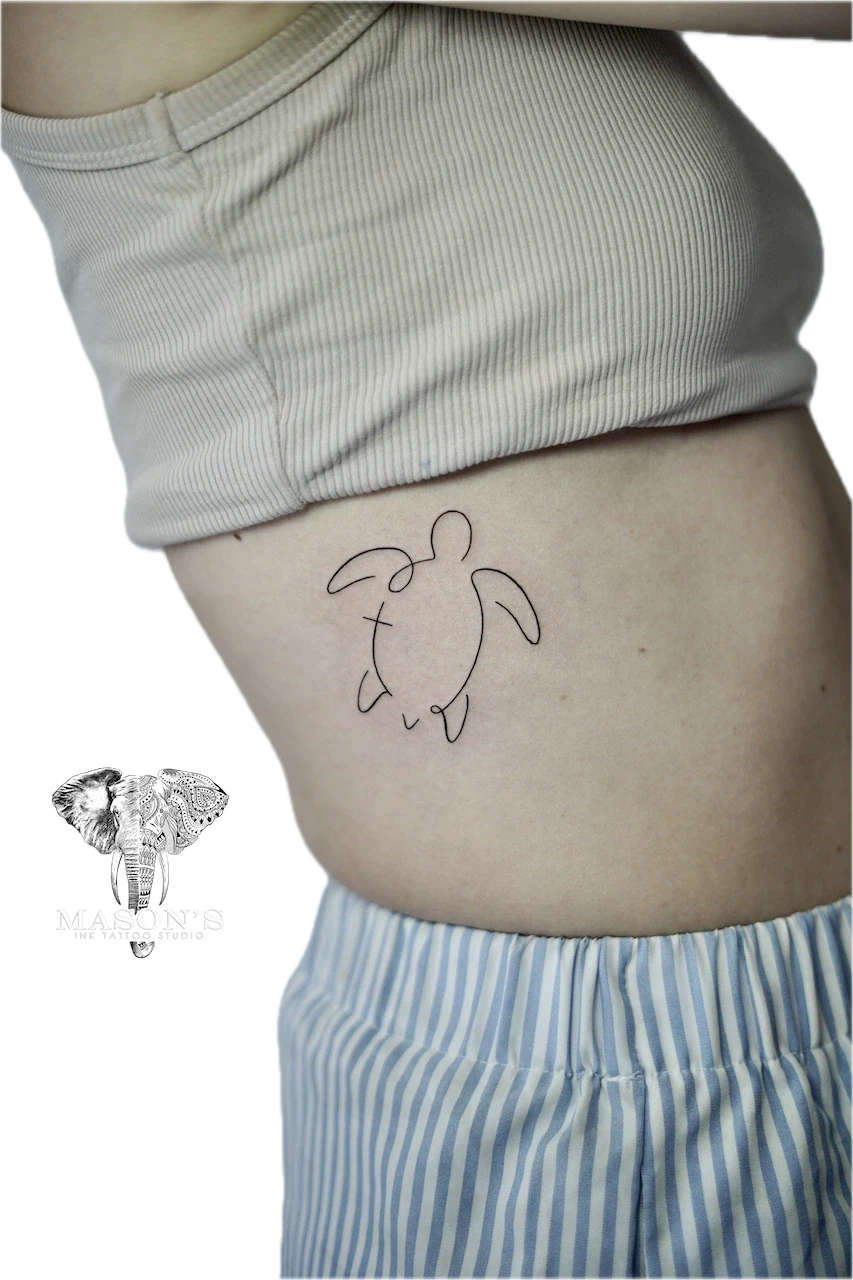 Fine Line Turtle Tattoo Design: a minimalist turtle tattoo on the hip