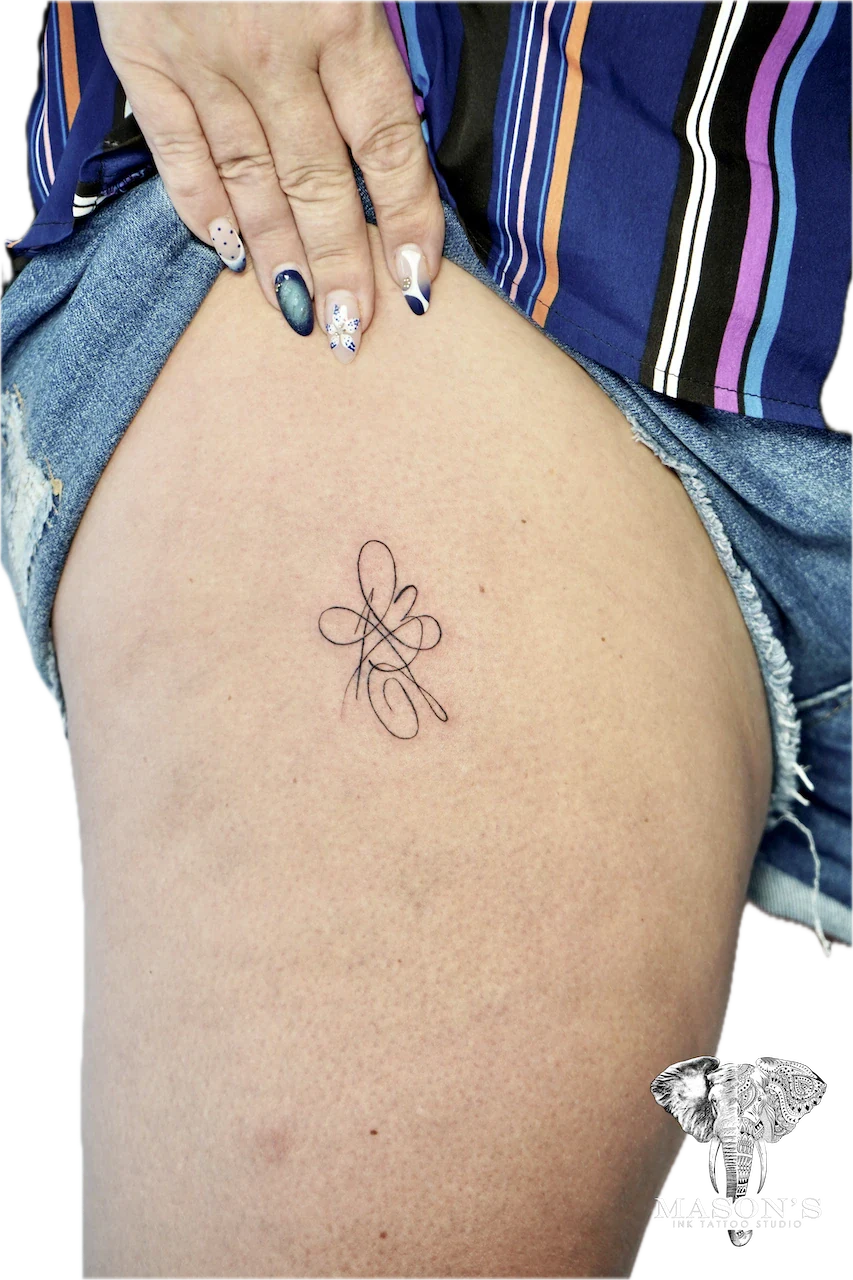 Fine Line Tattoo Design: a minimalist flower design on the hip