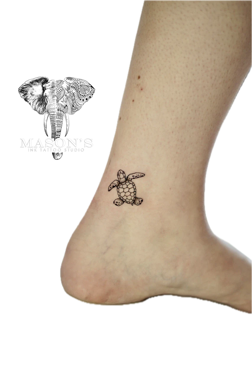 Fine Line Turtle Tattoo Design: a small black and grey turtle on the ankle