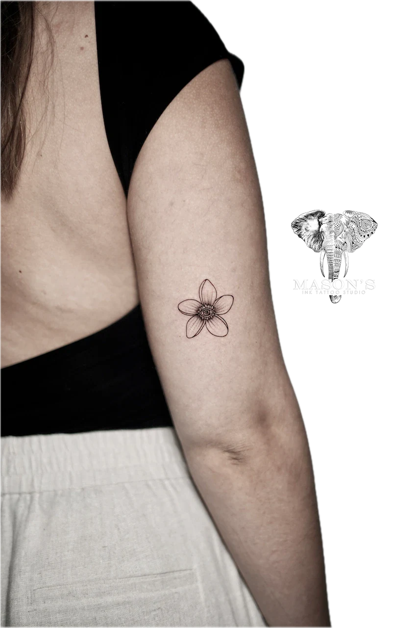 Fine Line Script Tattoo Design: a minimalist black and grey flower tattoo on the forearm