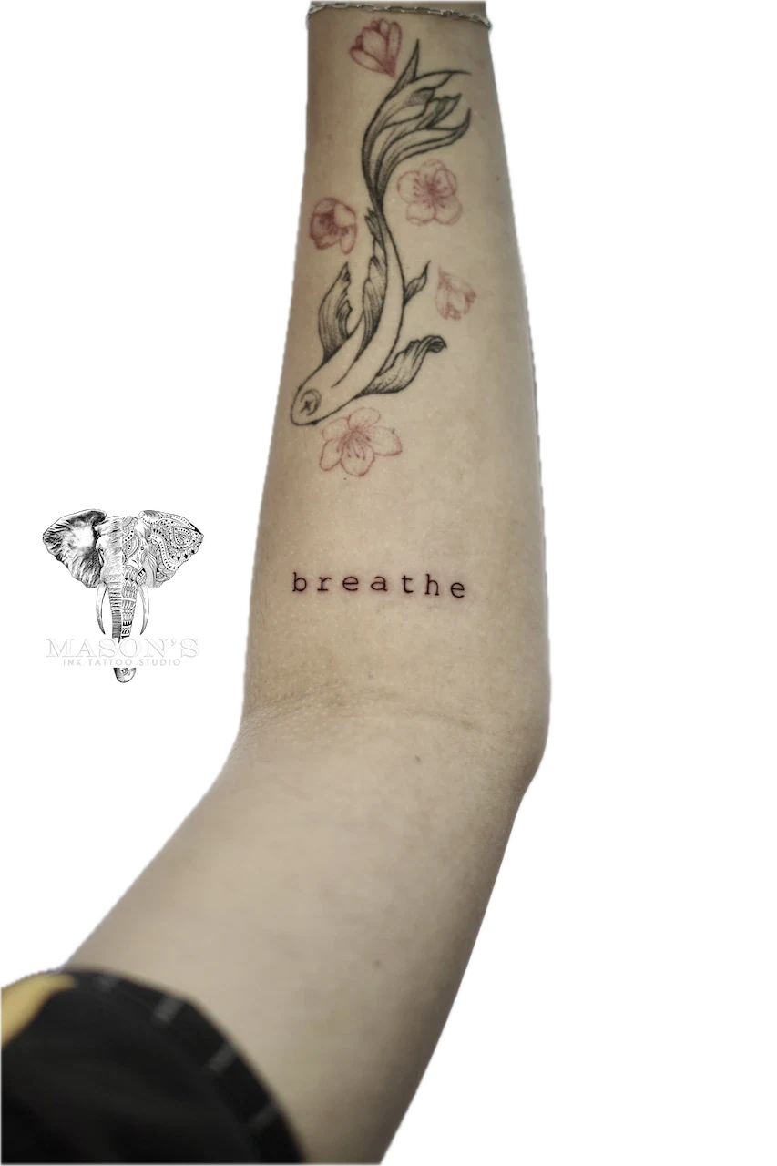 Fine Line Script Tattoo Design: a snake and flowers with the word breathe on a forearm