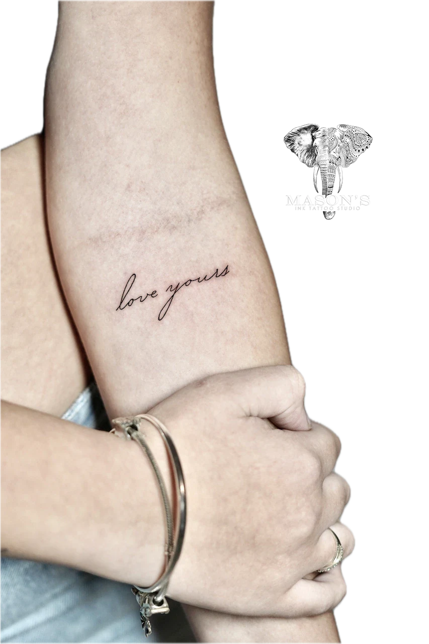 Fine Line Script Tattoo Design: Small forearm tattoo of the words 'love yours'