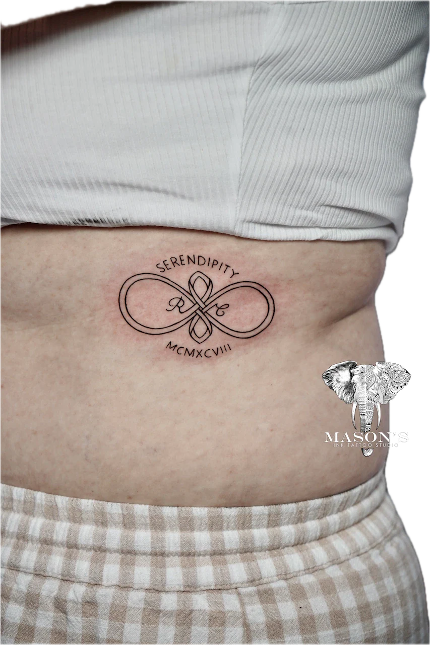 Fine Line Infinity Script Tattoo Design: Infinity symbol with flower and lettering on the stomach