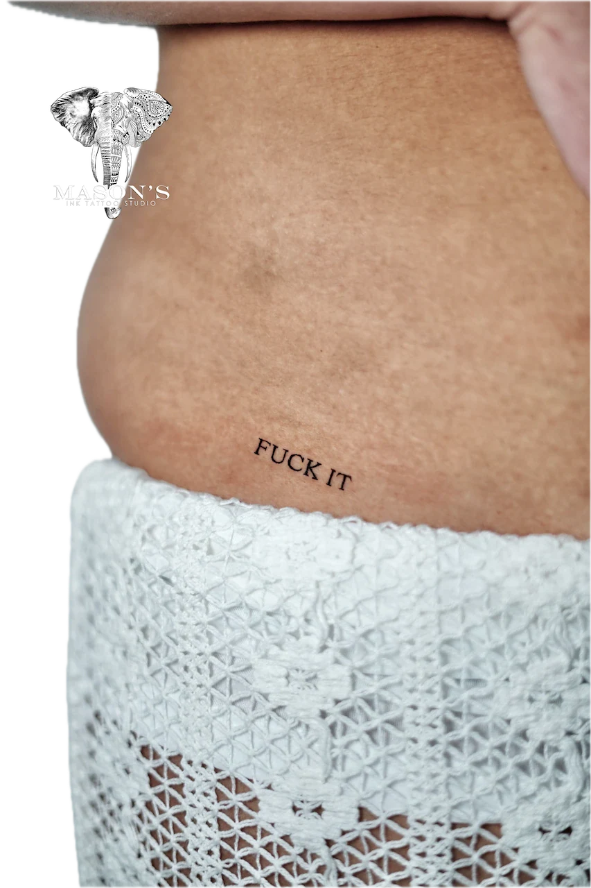Fine Line Script Tattoo: Small script lettering on the stomach
