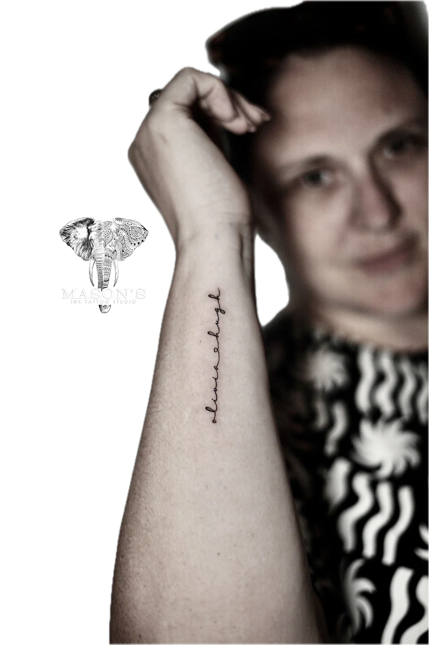 Fine Line Script Tattoo Design: Small black and grey lettering on the forearm