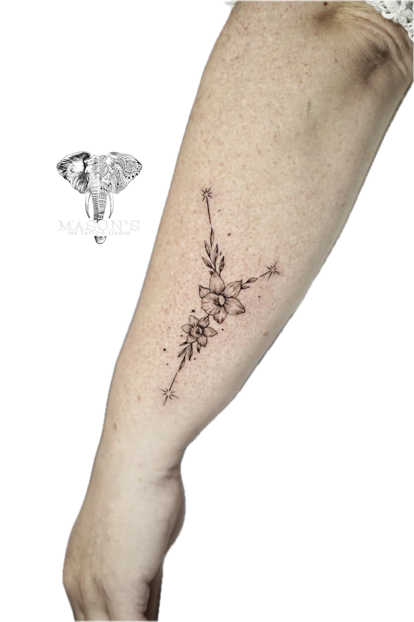 Fine Line Flower Tattoo Design: Delicate flowers and stars on a calf