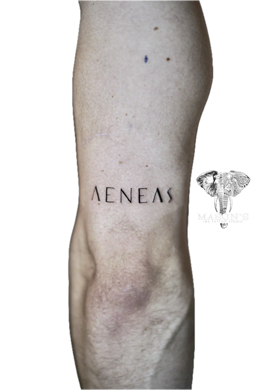 Fine Line Script Tattoo Design: Small black and grey lettering tattoo on the calf