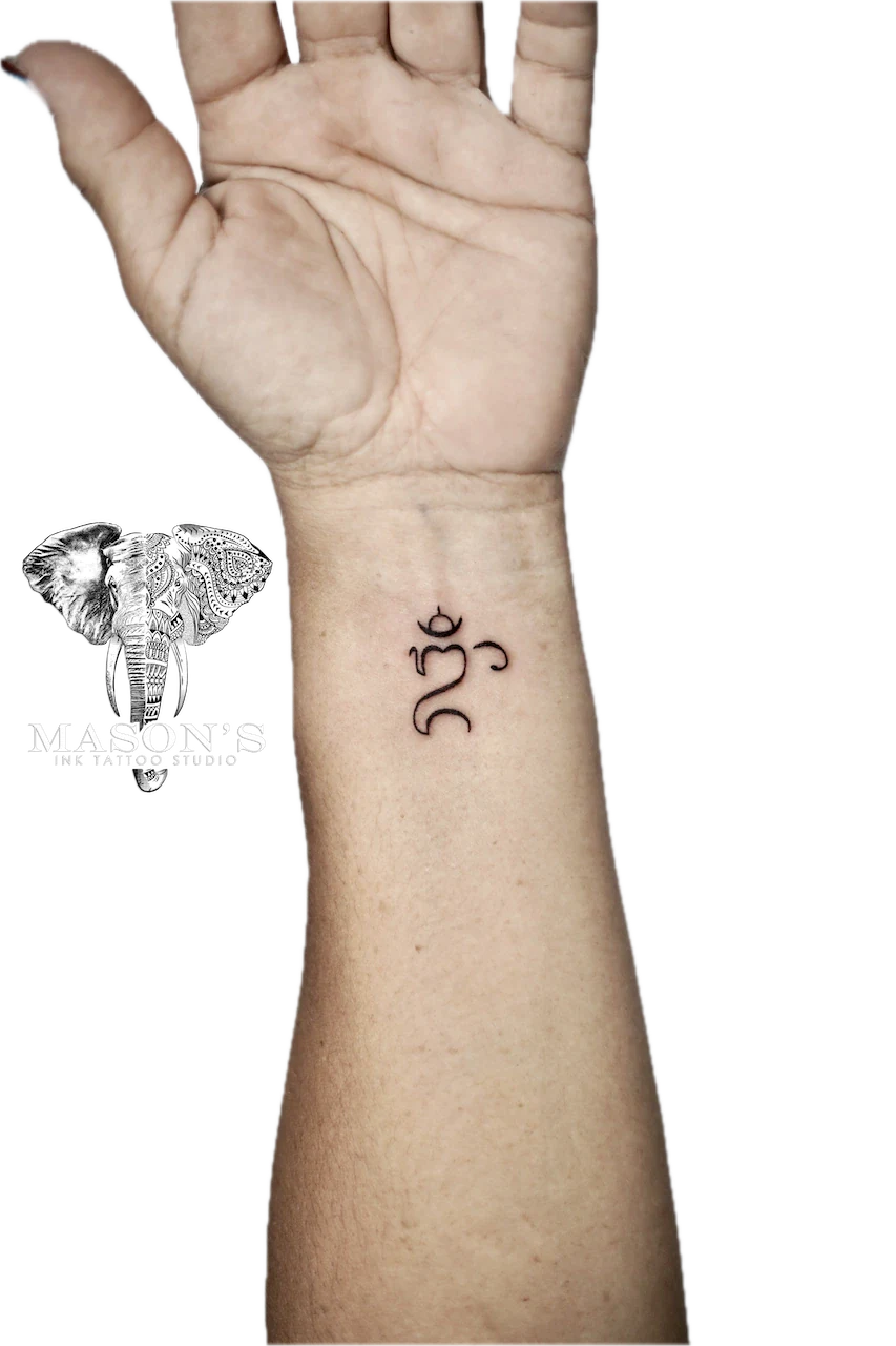 Fine Line Om Symbol Tattoo Design: Small spiritual symbol and lettering on the forearm
