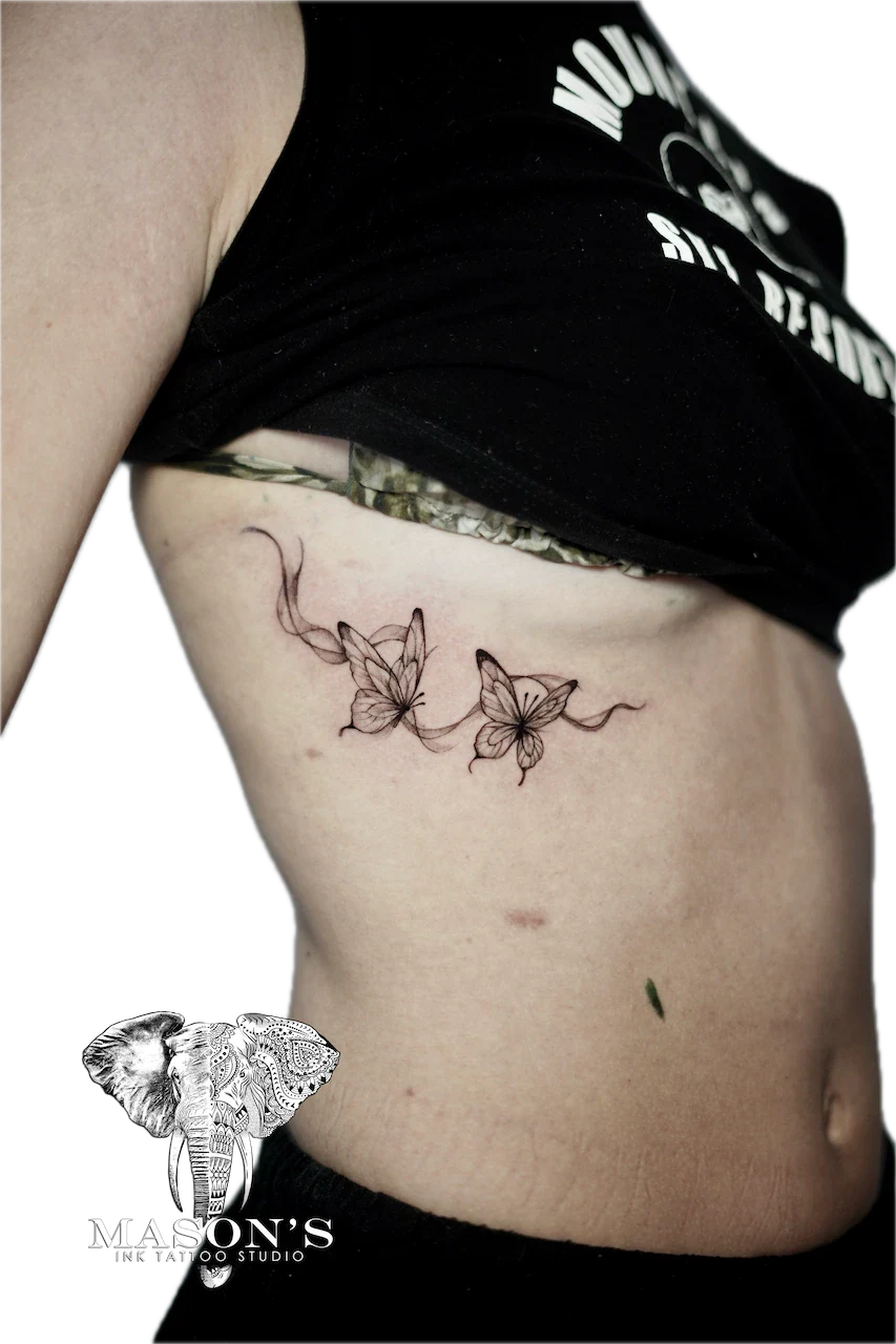 Fine Line Butterfly Tattoo Design: Two delicate flowers with vines on the stomach