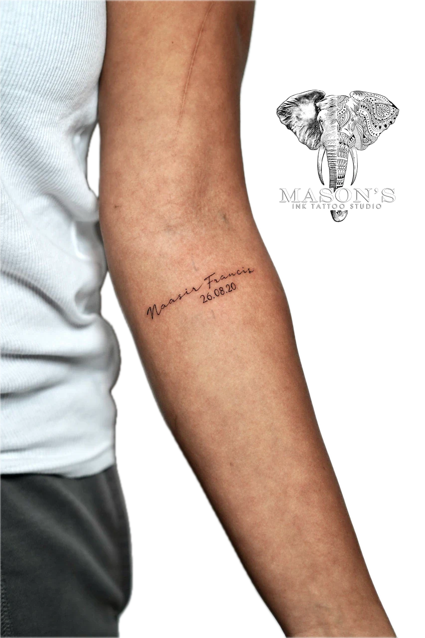 Fine Line Script Tattoo Design: a memorial tattoo with a name and date on the forearm