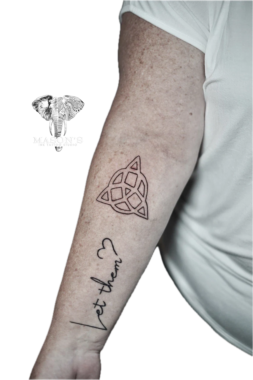 Fine line trinity knot and script tattoo on forearm by Mason's Ink Tattoo Studio, Bali