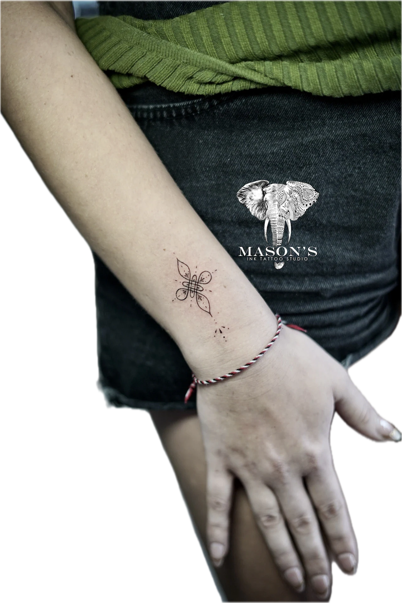 Fine Line Tattoo Design: a small black and grey mandala tattoo on the wrist