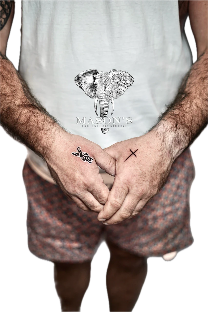 Fine Line Cross Tattoo Design: an elephant head with intricate mandala patterns and lettering