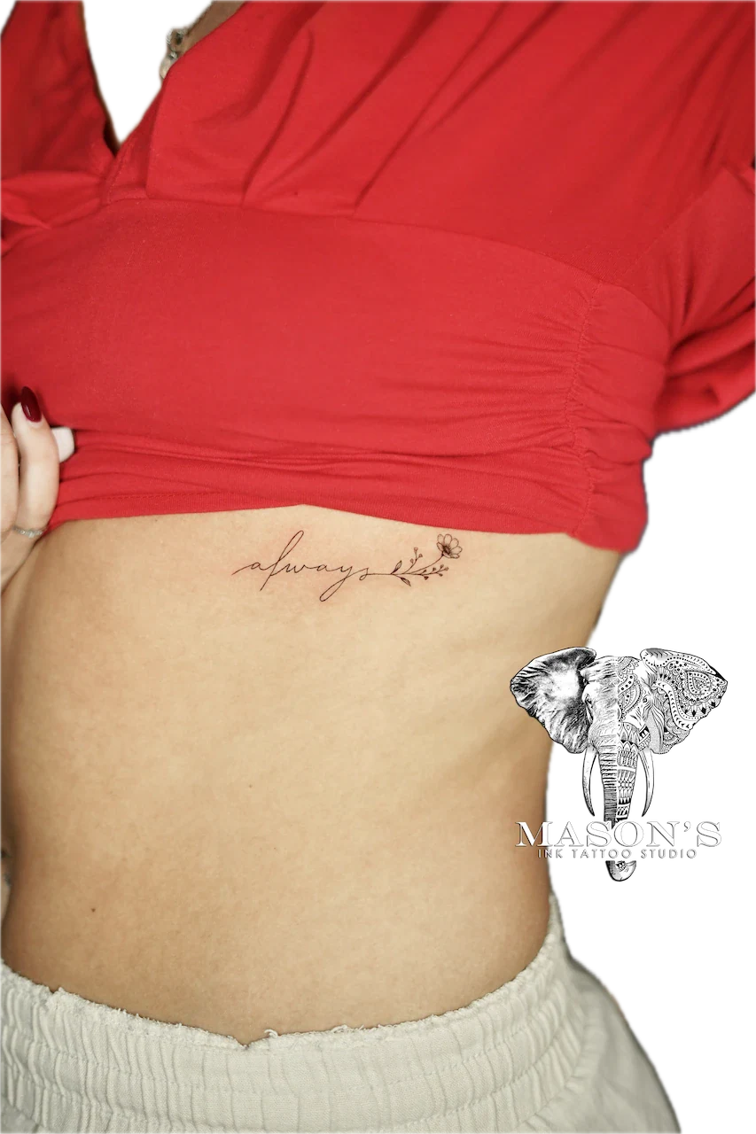 Fine Line Floral Script Tattoo Design: Small heart and rose with lettering on the stomach