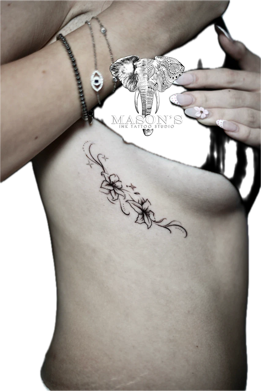 Fine Line Floral Tattoo Design: a delicate black and grey floral tattoo on the ribs
