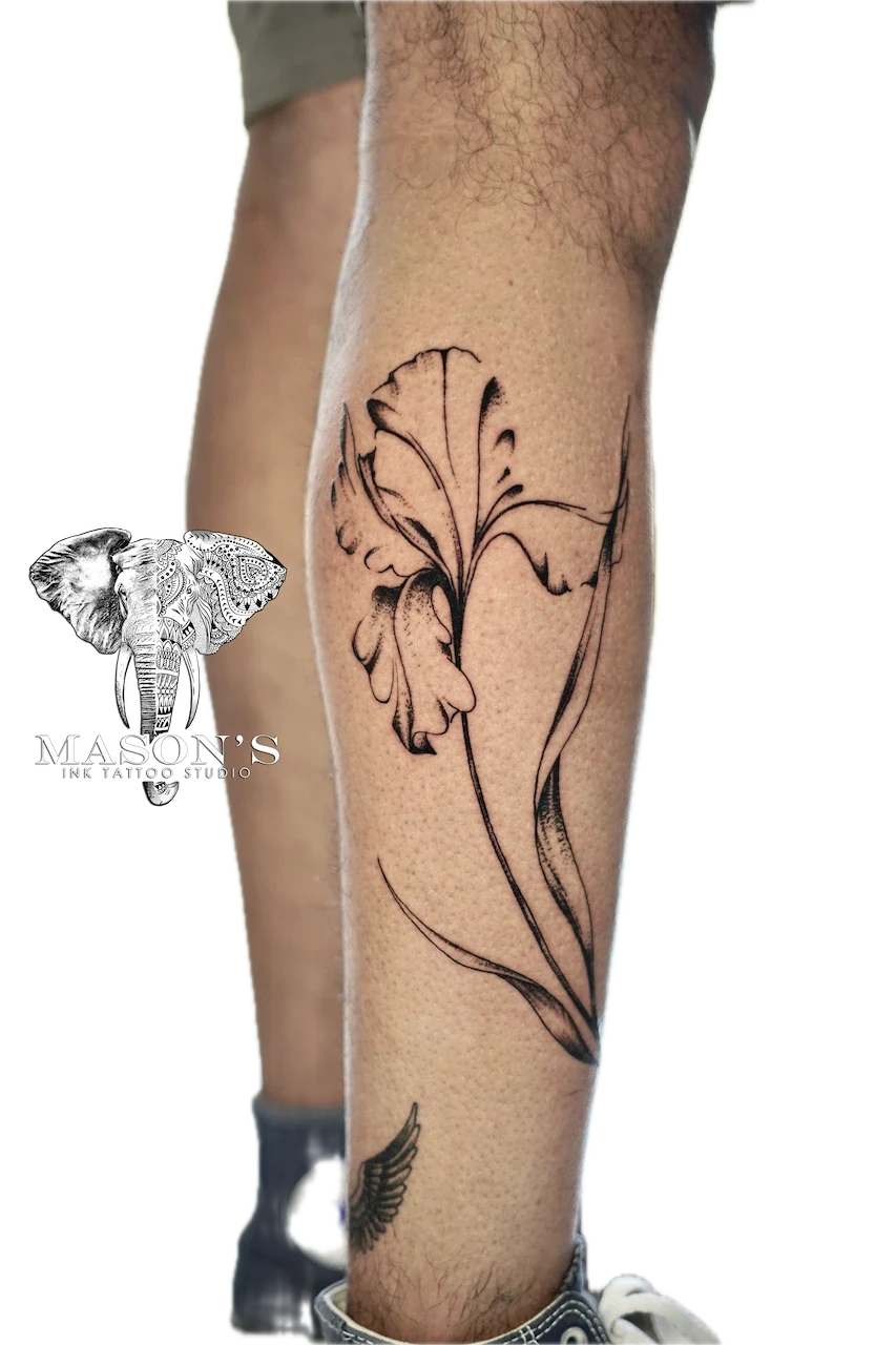 Fine Line Floral Tattoo Design: a detailed leaf and stem tattoo on the calf