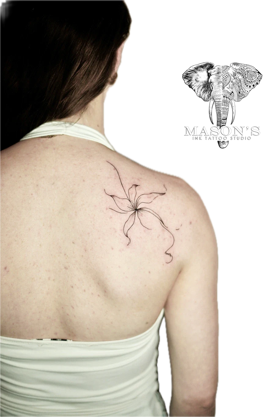 Fine Line Floral Tattoo Design: a delicate black and grey flower tattoo on the shoulder