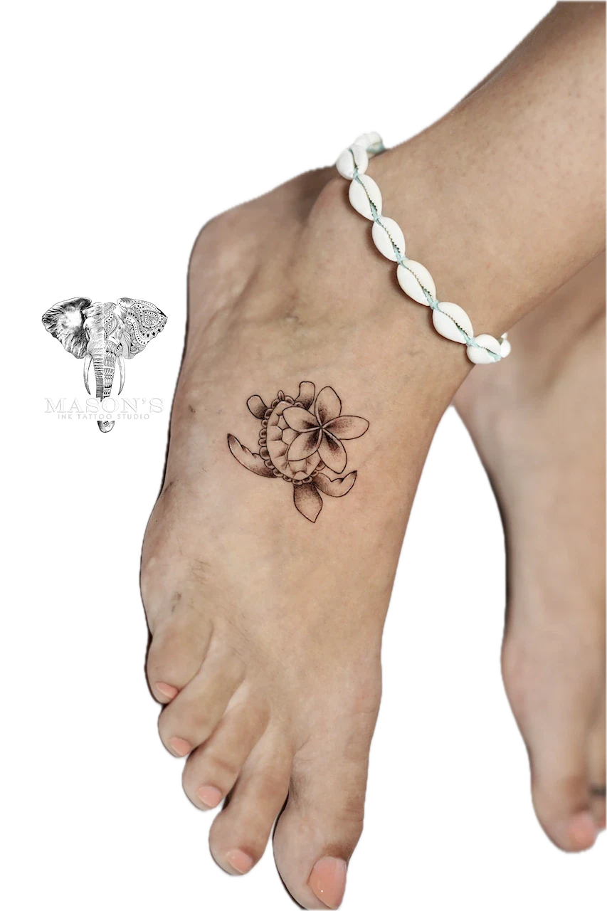 Fine Line Floral Turtle Tattoo Design: a delicate flower and shell tattoo on the ankle with a bracelet