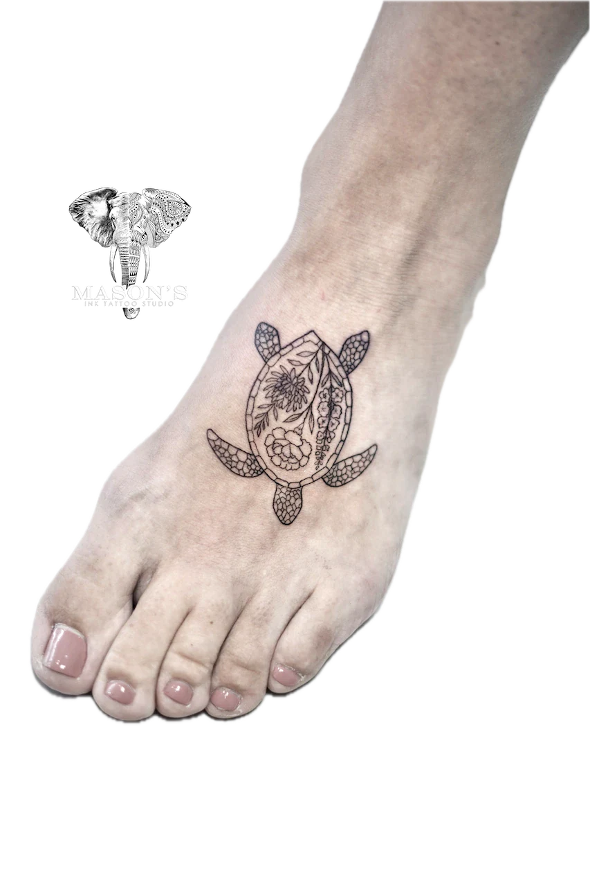 Fine Line Floral Turtle Tattoo Design: a small geometric turtle tattoo with floral details on the foot