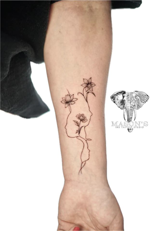 Fine line flower tattoo running down the forearm