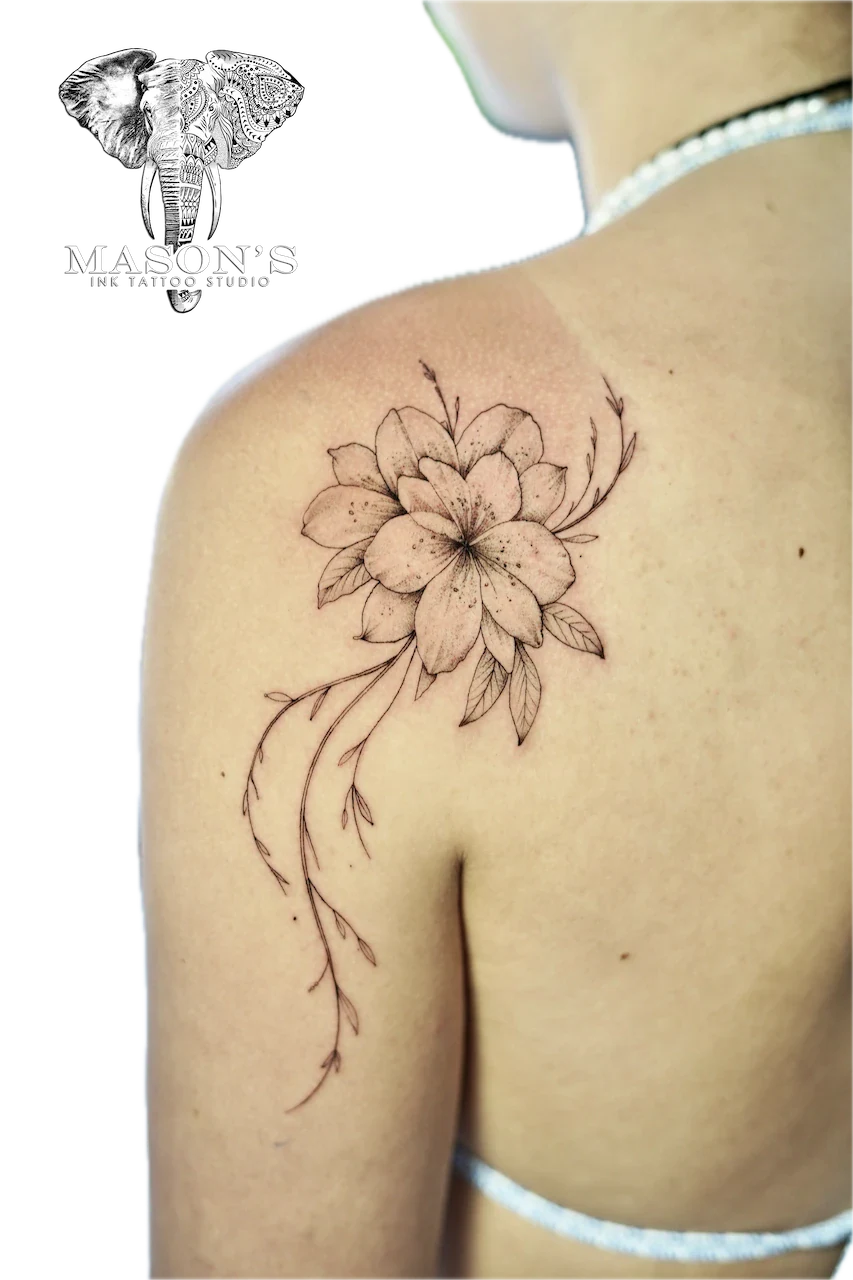 Fine Line Flower Tattoo Design: a delicate flower and vine tattoo on the shoulder