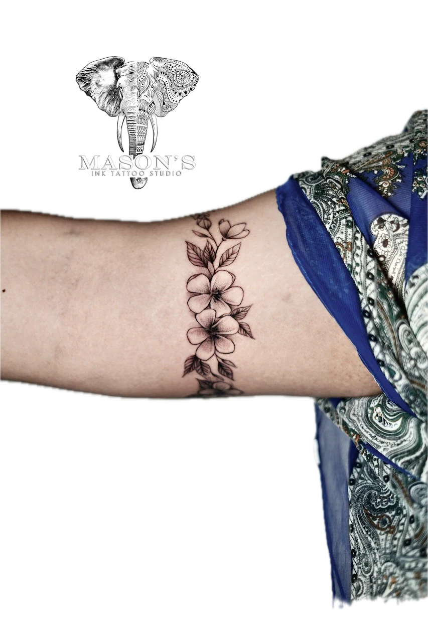 Fine Line Flower Tattoo Design: a delicate vine of flowers on the forearm