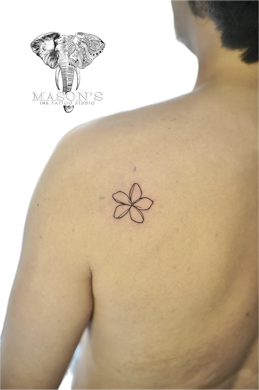 Fine Line Flower Tattoo Design: a small, minimalist flower tattoo on the shoulder