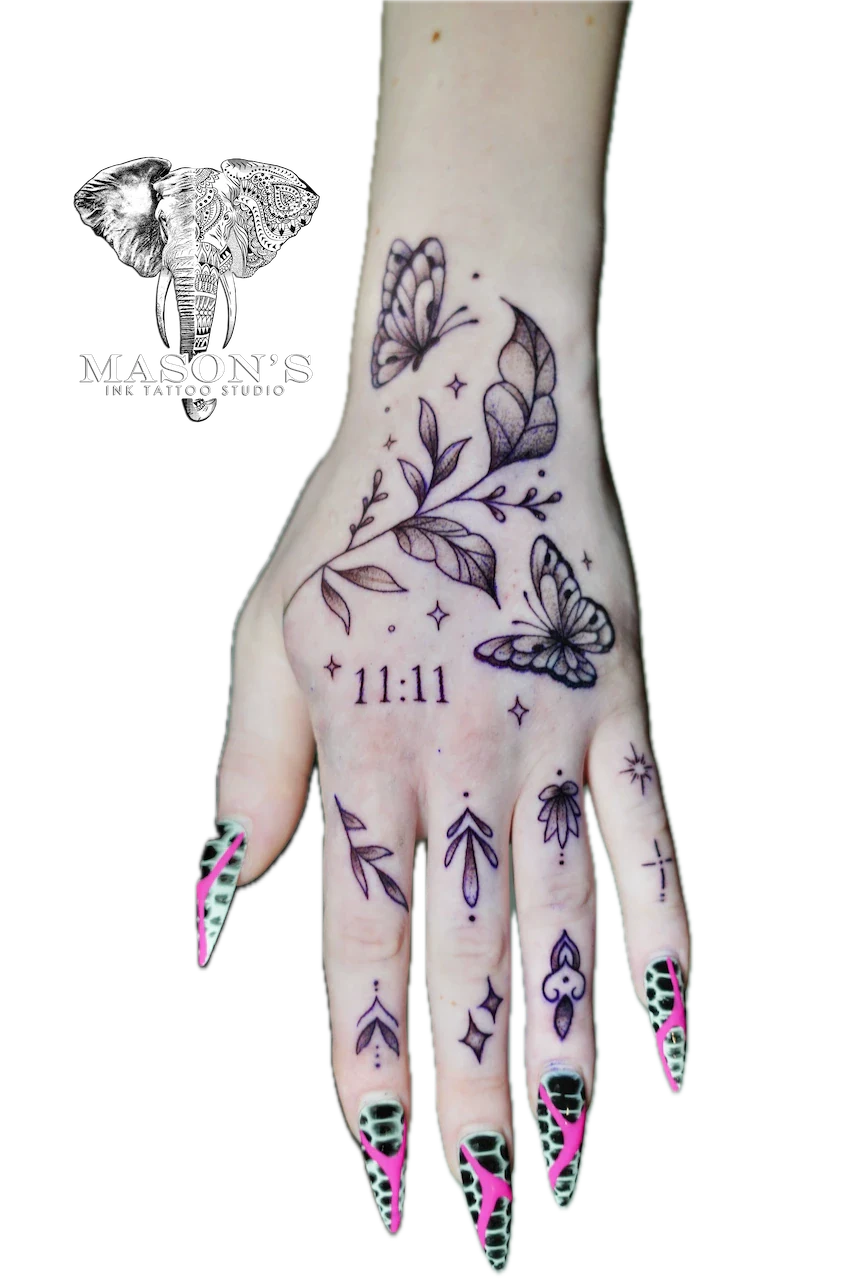 Fine Line Flower Tattoo Design: Minimalist hand tattoo with butterflies, leaves, and stars