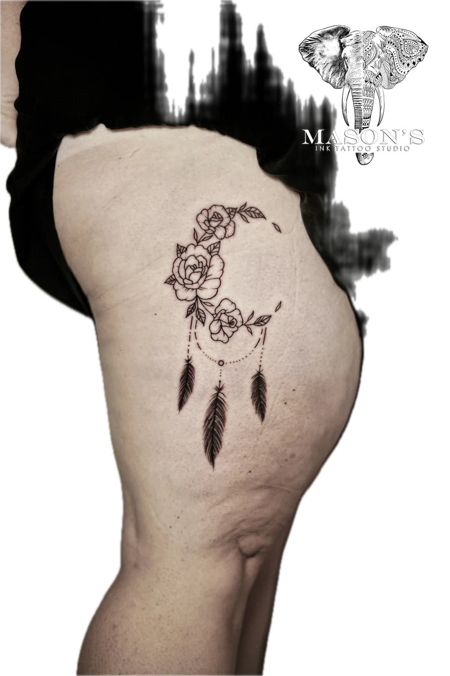 Fine Line Flower Tattoo Design: a dreamcatcher with roses and feathers on the thigh