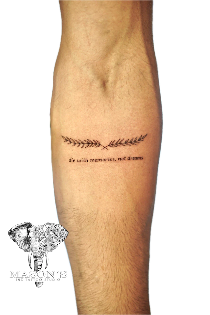 Fine Line Leaf and Script Tattoo Design: Minimalist lettering and laurel with a cross on a calf